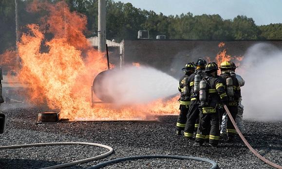 Photo of firefighters fighting a training fire outside
